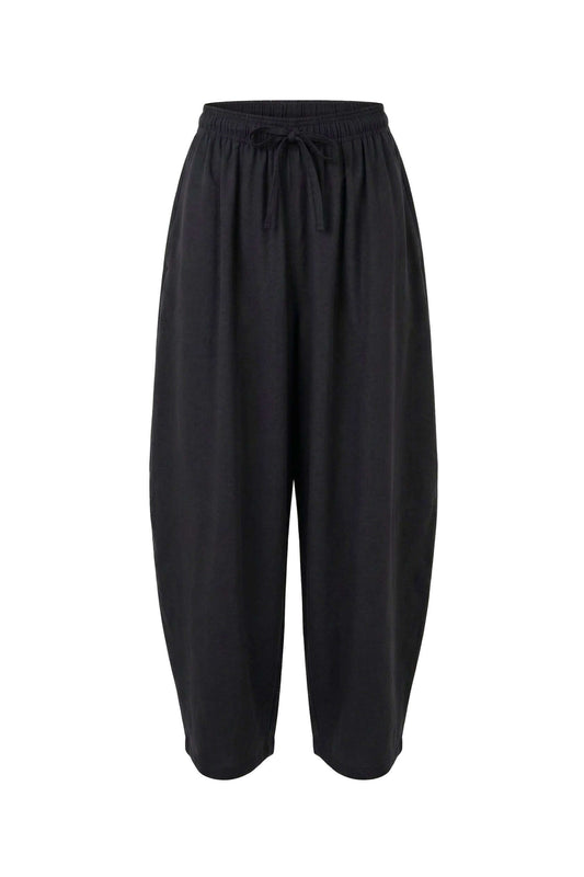 Black Lyocell Barrel-Leg Trousers with exaggerated silhouette and elasticated waist for a relaxed fit.