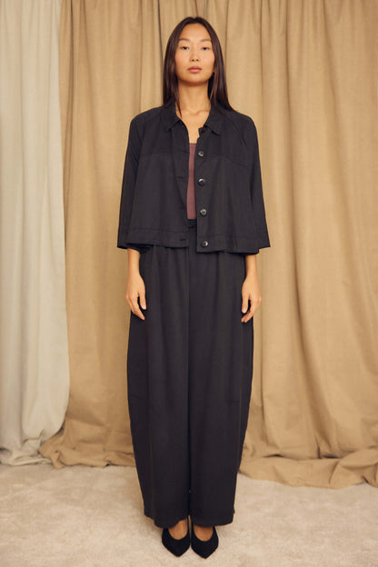 Model wearing Black Lyocell Barrel-Leg Trousers paired with a matching cropped jacket on a neutral background.