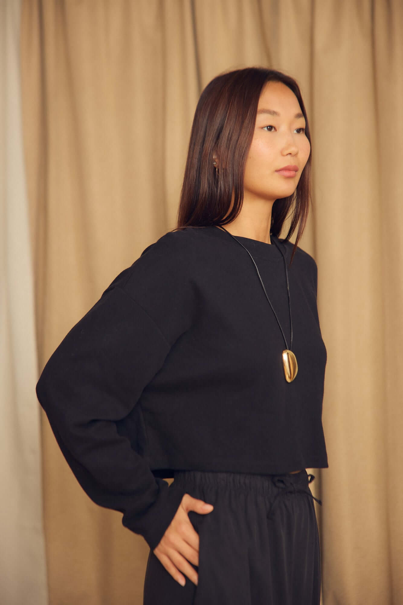 Model wearing a Black Organic Cotton Oversized Crop Top, showcasing its relaxed and contemporary silhouette.
