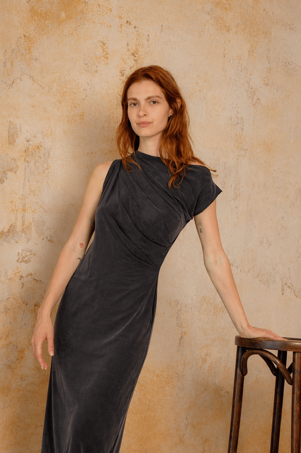 Drape Cupro Midi Dress in Slate Black showcased on a model against a textured background.