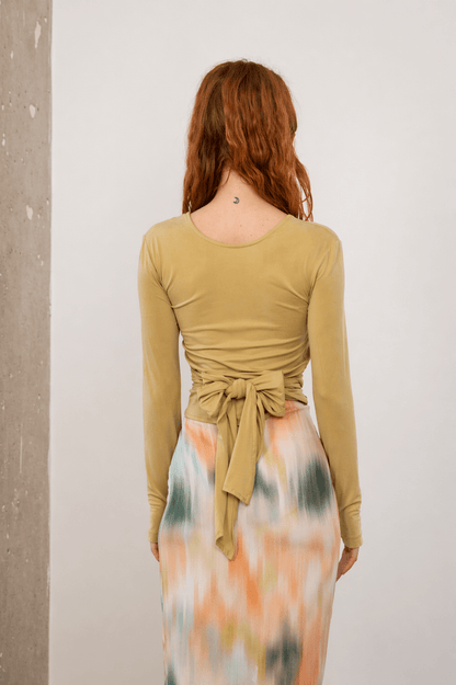 Cupro Multiway Wrap Top in Soft Olive, back view showcasing multiway design and soft jersey fabric.