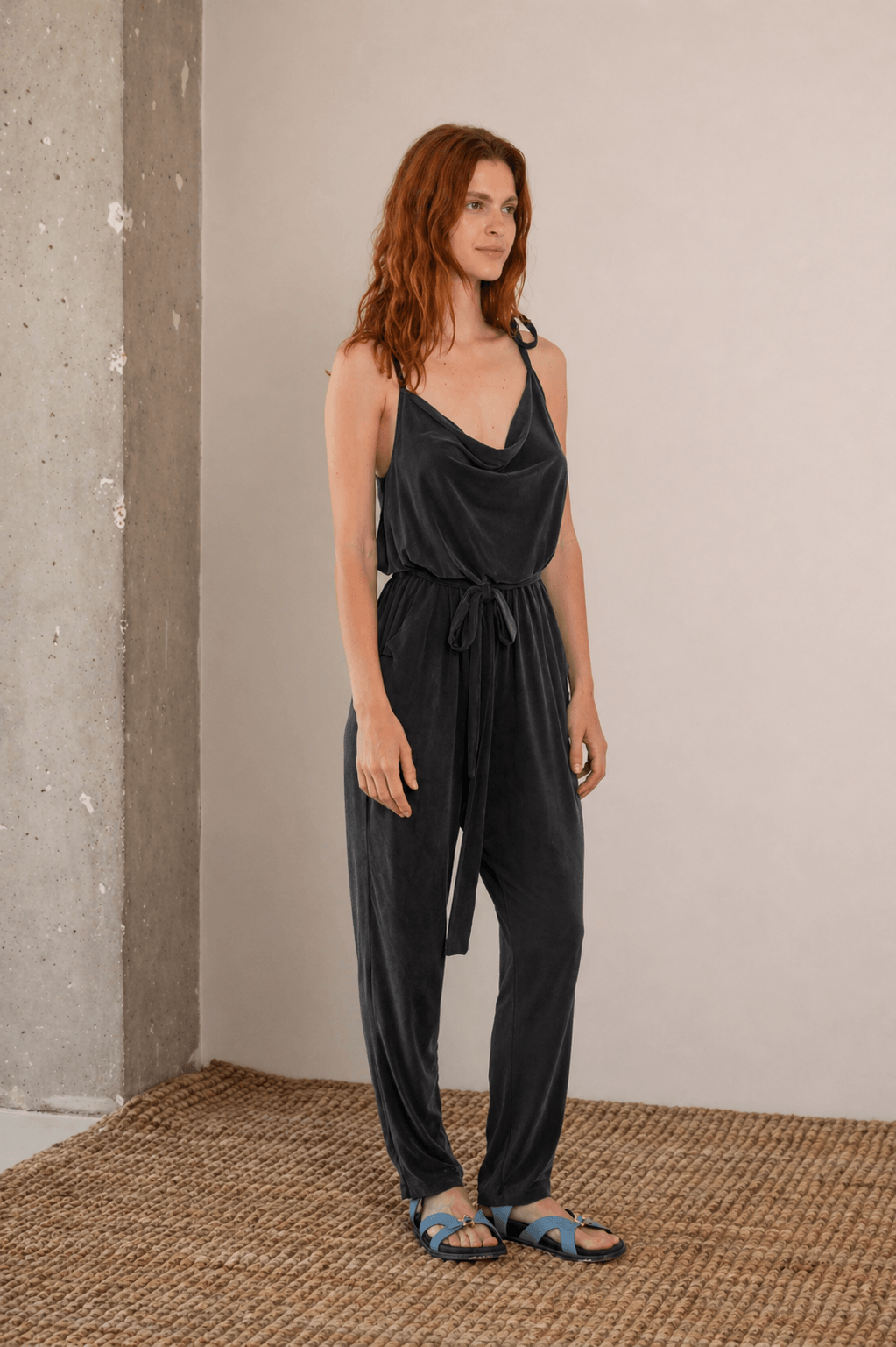 Cupro Slip Jumpsuit with Belt in Slate Black worn by model, showcasing relaxed elegance and versatility.