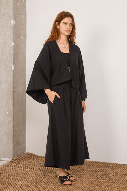 Organic Cotton Wide Culottes in Black displayed on a model, showcasing relaxed silhouette and modern styling.