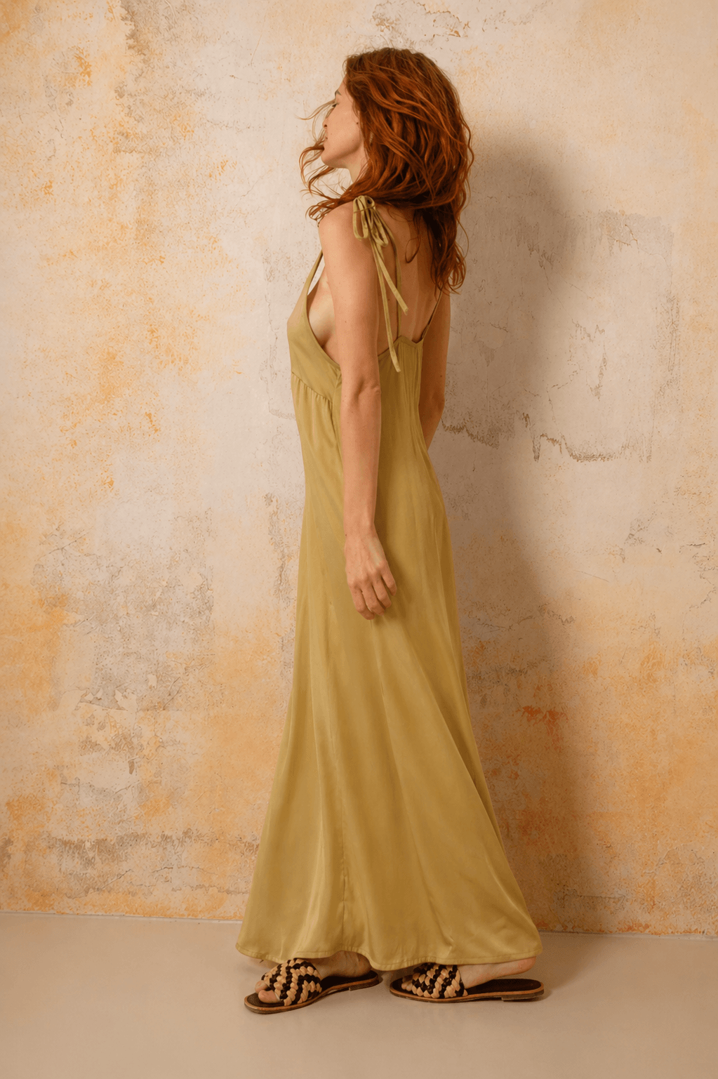 Ecovero Maxi Dress in Soft Olive showcased on a model from the side, highlighting its flowy design and adjustable straps.