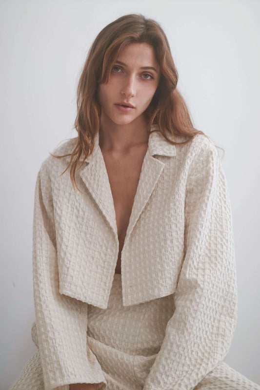 ECRU WAFFLE CROP JACKET worn by a model, showcasing its lightweight and stylish design.