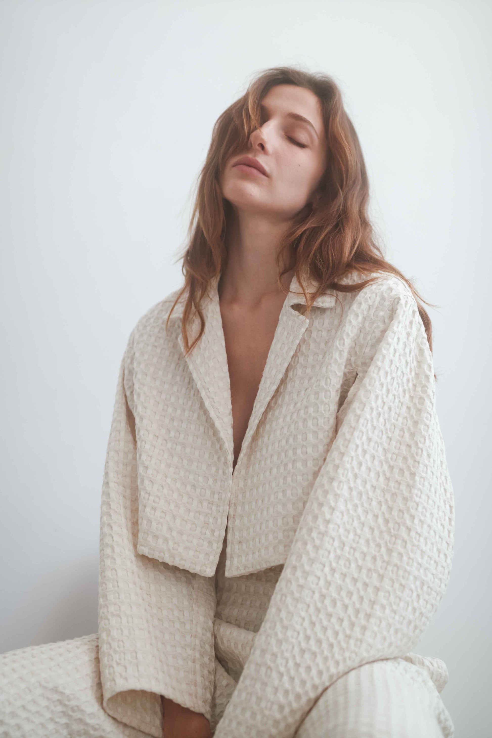 Model wearing ECRU WAFFLE CROP JACKET showcasing its lightweight design and breathable fabric.
