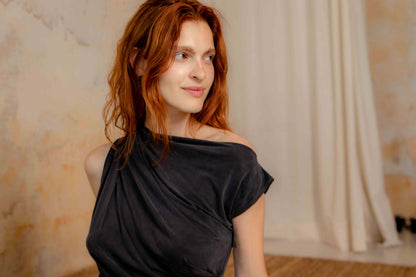 Drape Neckline Cupro Top in Black worn by a model with wavy red hair, showcasing soft elegance and fluid design.