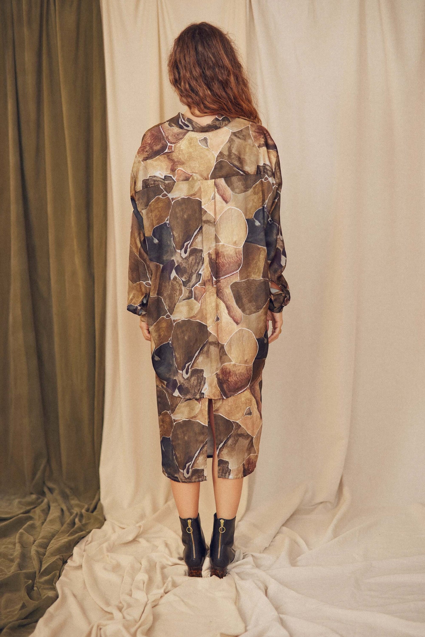 Back view of a model wearing a multicolour Printed Ecovero Pencil Midi Skirt, showcasing its eco-friendly design.
