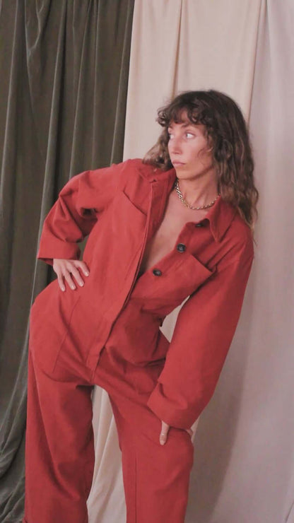 Model wearing a Rust Organic Cotton Boiler Suit, showcasing its stylish design and eco-friendly materials.