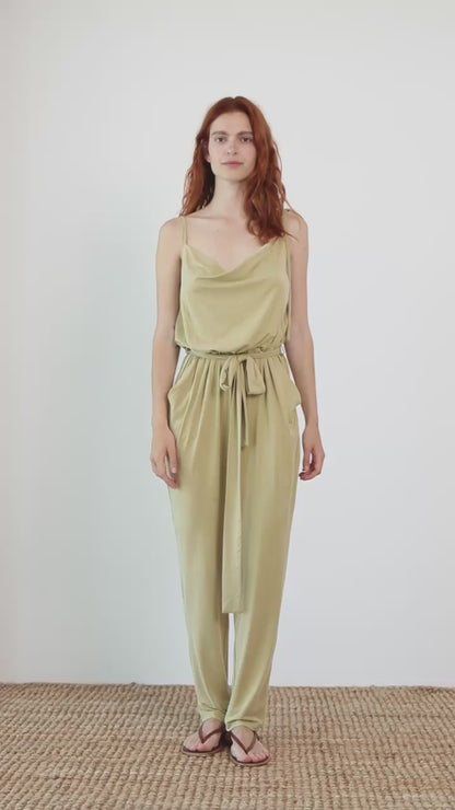 Cupro Slip Jumpsuit with Belt in Olive worn by a model, showcasing its modern and elegant design.