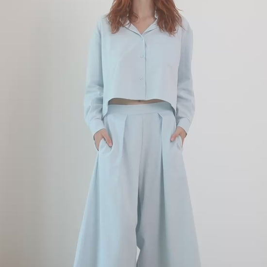 Model wearing Organic Cotton Wide Culottes in Pale Blue with a matching cropped top and sandals.