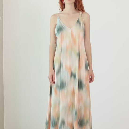 Model wearing a Printed Ecovero Viscose Maxi Dress in soft colors, showcasing adjustable straps and a flowing design.