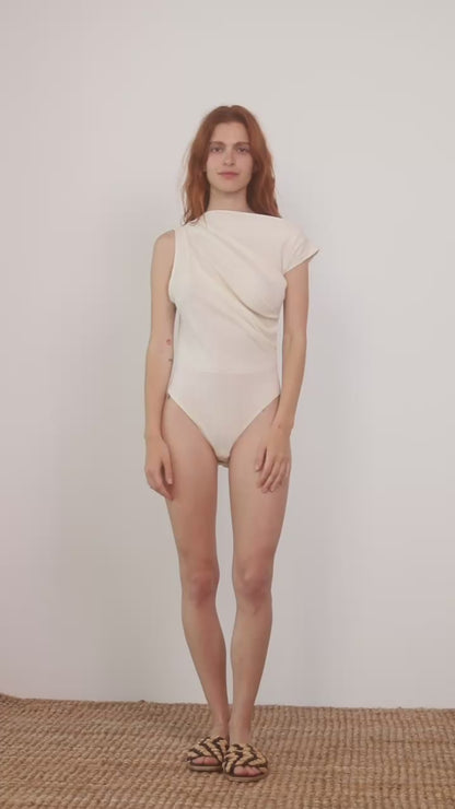 Model wearing the Banana Pineapple Drape Neckline Bodysuit in Ecru, showcasing its elegant draped design.