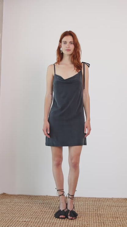 Cupro Drape Slip Mini Dress in Slate Black worn by model, featuring draped neckline and adjustable straps.