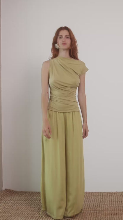 Wide Ecovero Trousers in Soft Olive displayed on model, showcasing elegant silhouette and sustainable fabric.