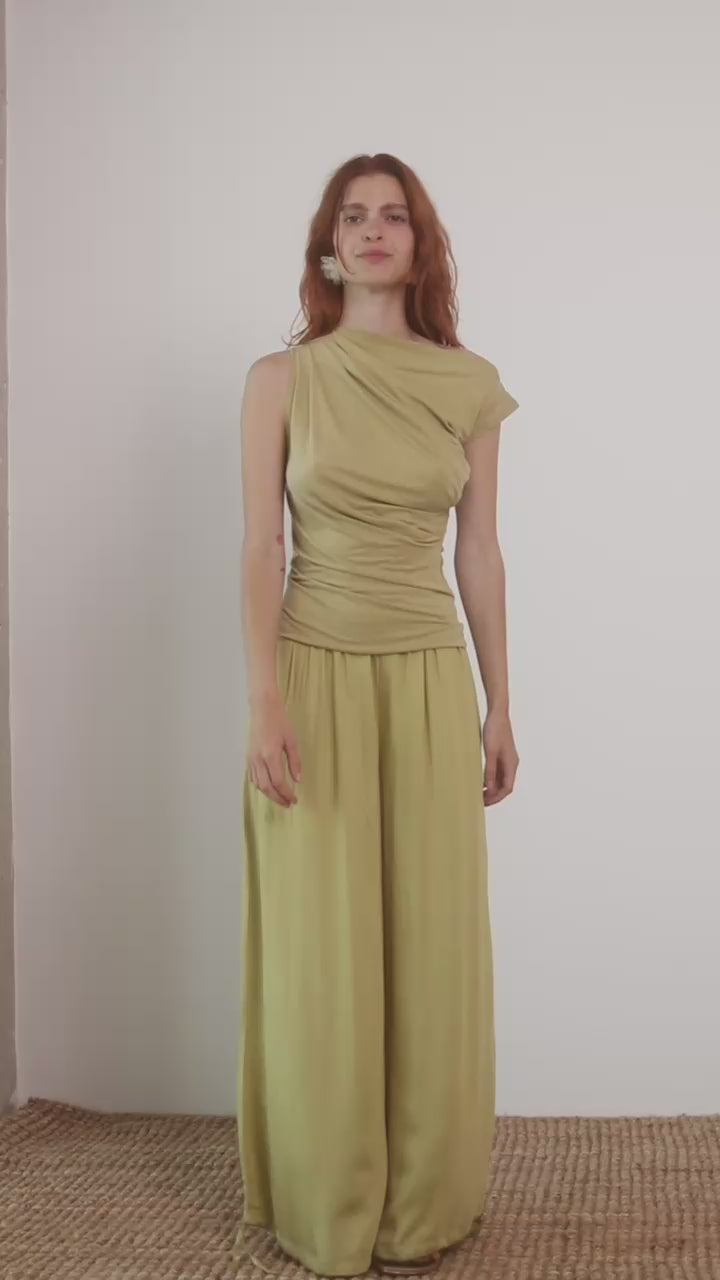 Wide Ecovero Trousers in Soft Olive displayed on model, showcasing elegant silhouette and sustainable fabric.